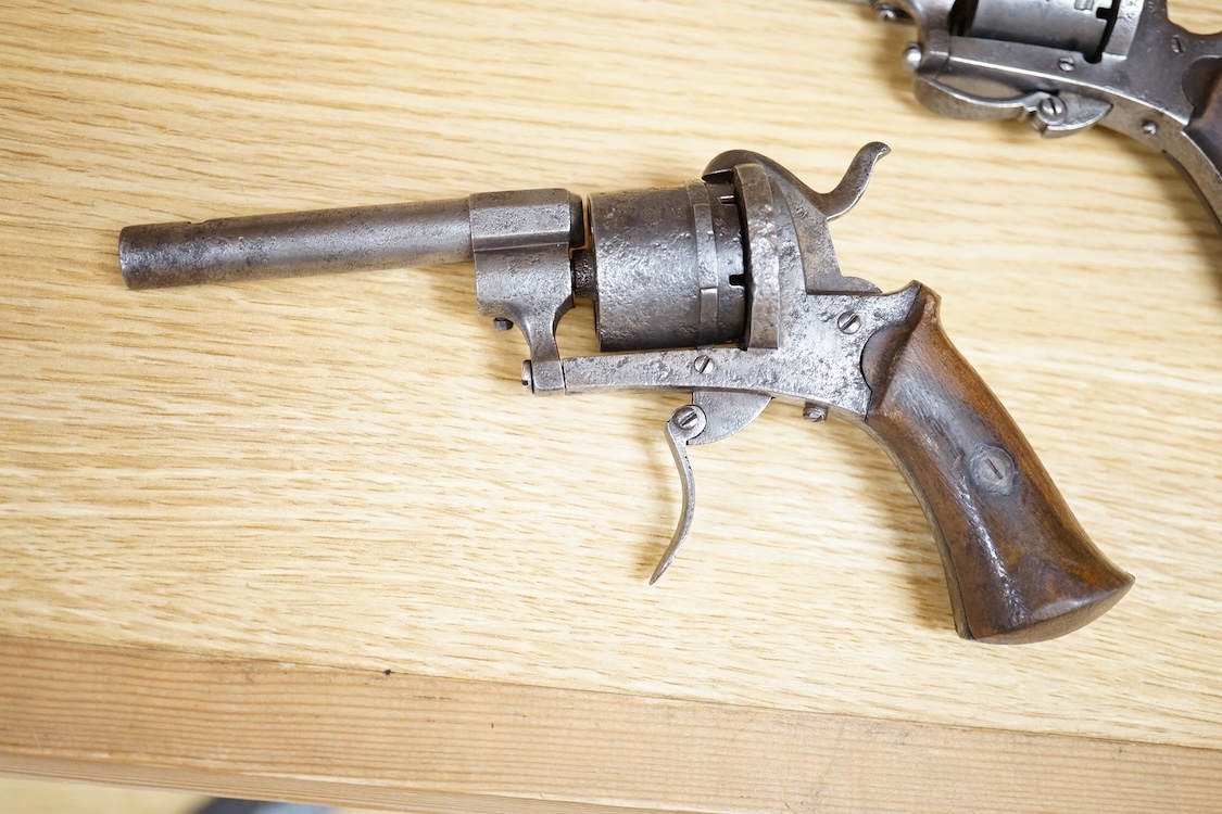 A six shot 7mm Belgian pinfire revolver and another similar, both with folding triggers and wooden grips